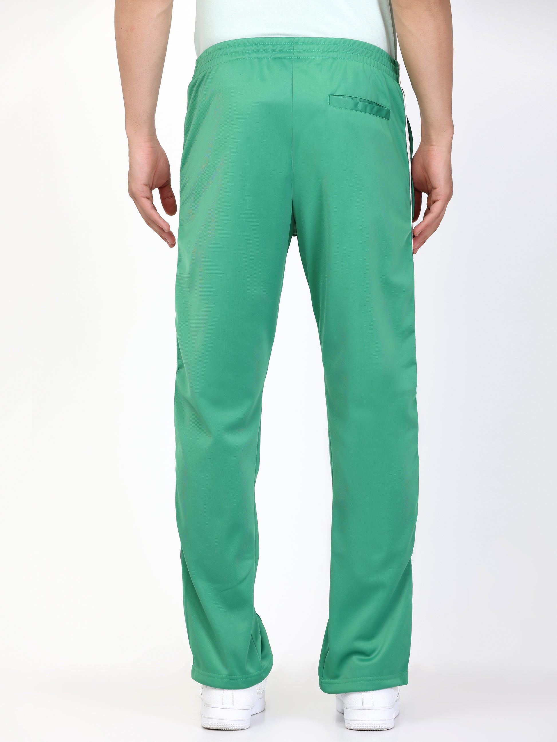 Green track pants with white side stripes and an elasticated waistband, with pockets.