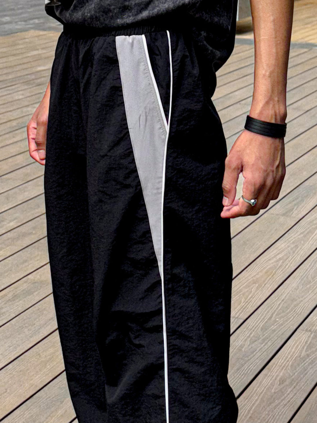 black trackpants with contrast white piping details