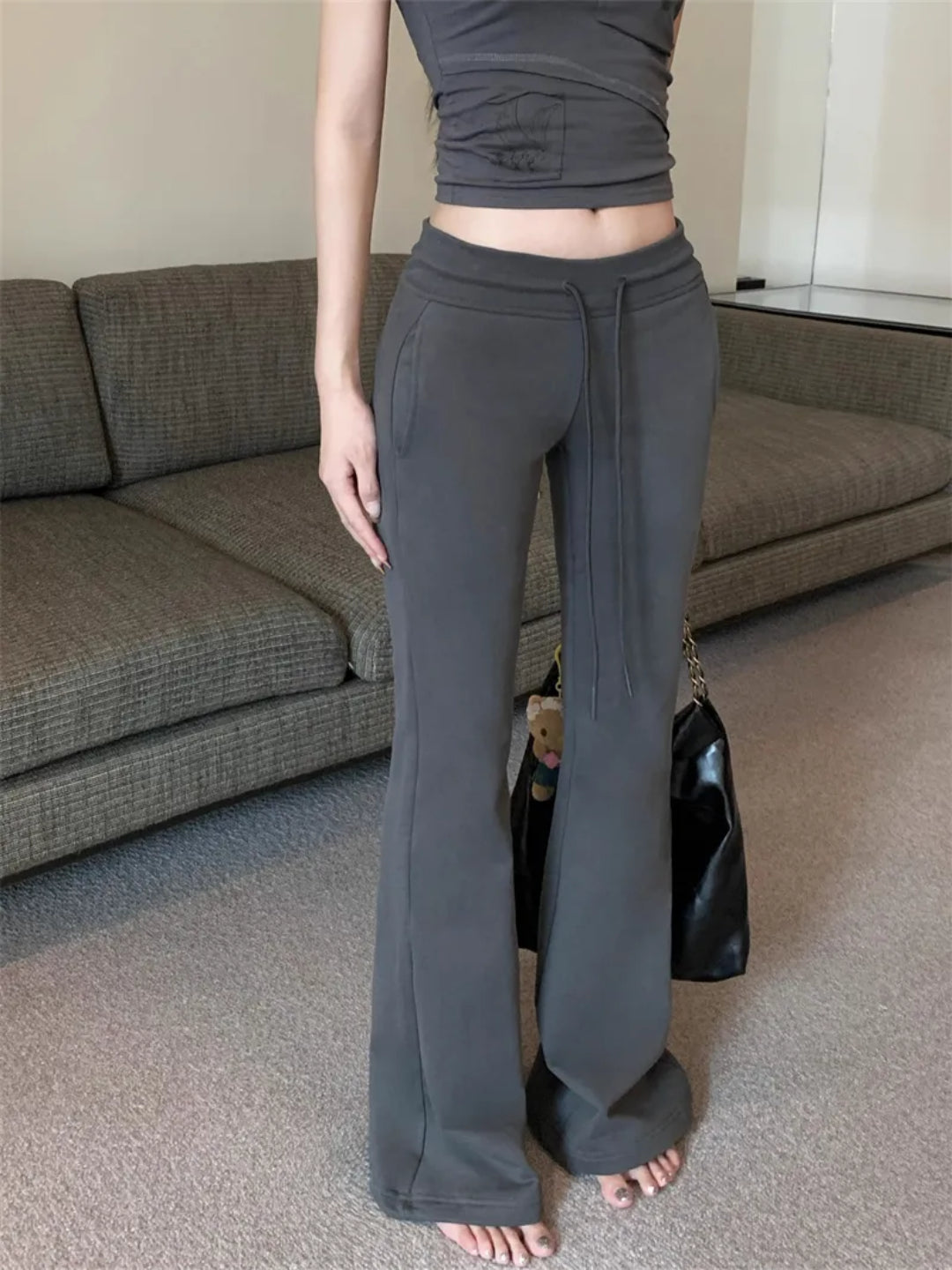 dark grey flared sweatpants with an elasticized waistband and drawstrings