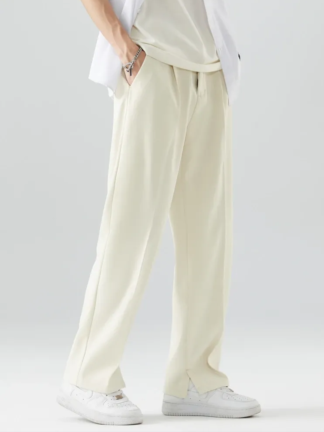 A person wearing White Tek Air loose fit pants and a white shirt, standing against a white background.