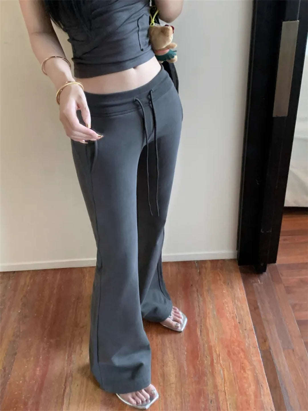 dark grey flared sweatpants with an elasticized waistband and drawstrings