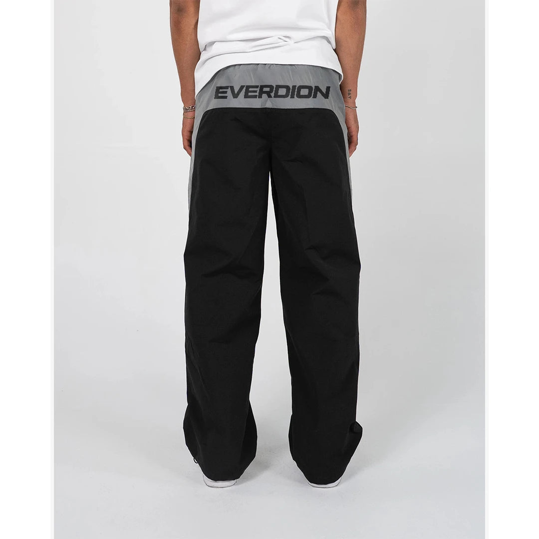 Person wearing black pants with 'EVERDION' branding on a white background