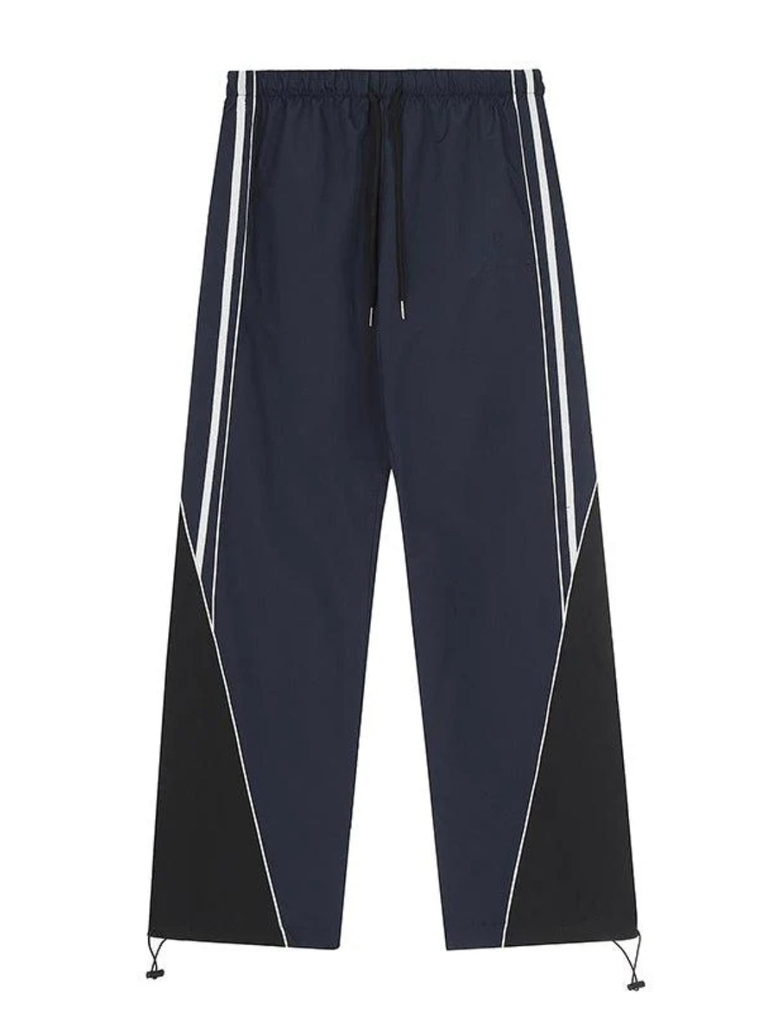 wearing striped parachute pants with contrast piping and an elasticated waistband with adjustable drawstrings.