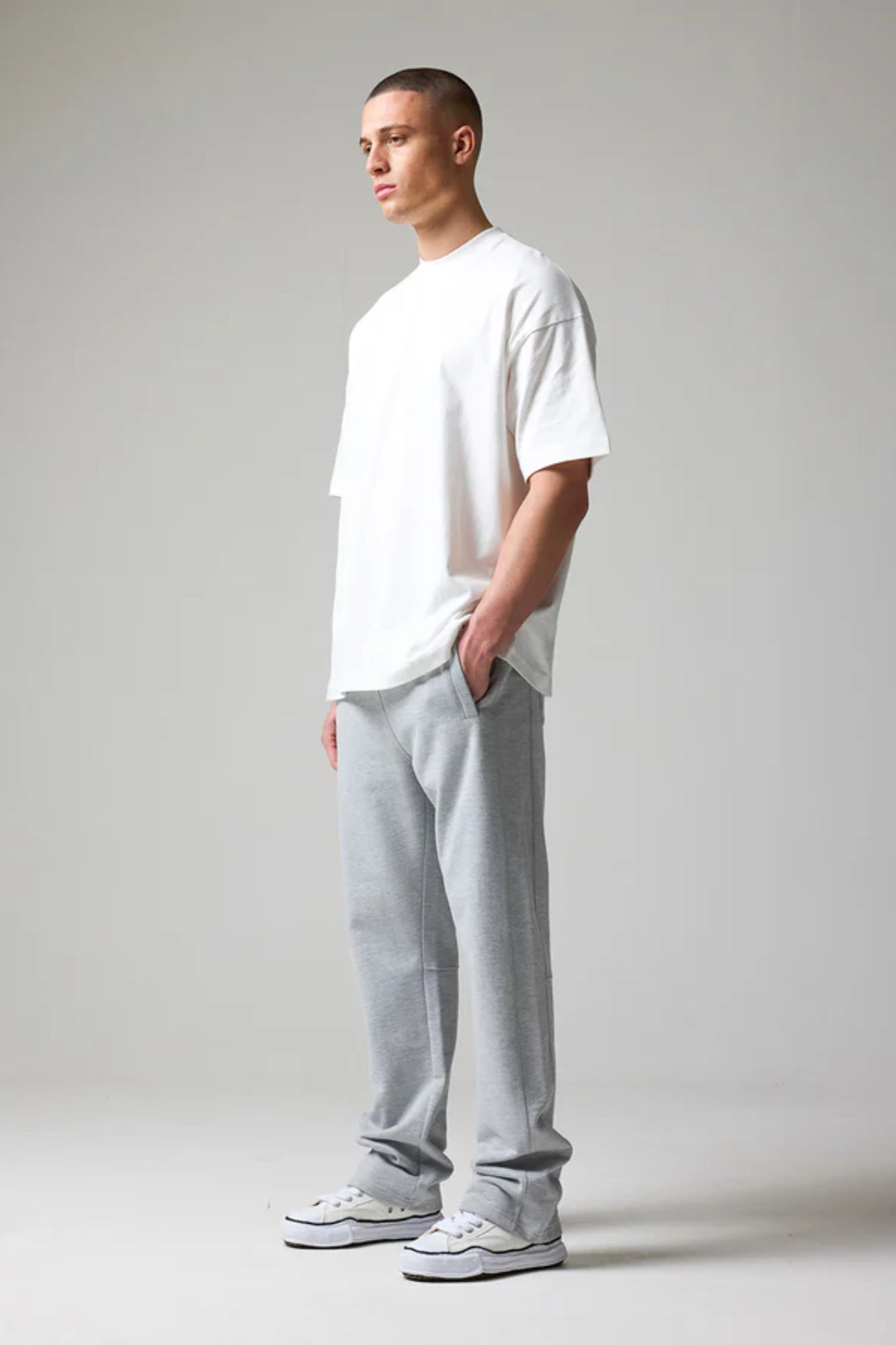 wearing grey open hem joggers with an elastic waistband and drawstring