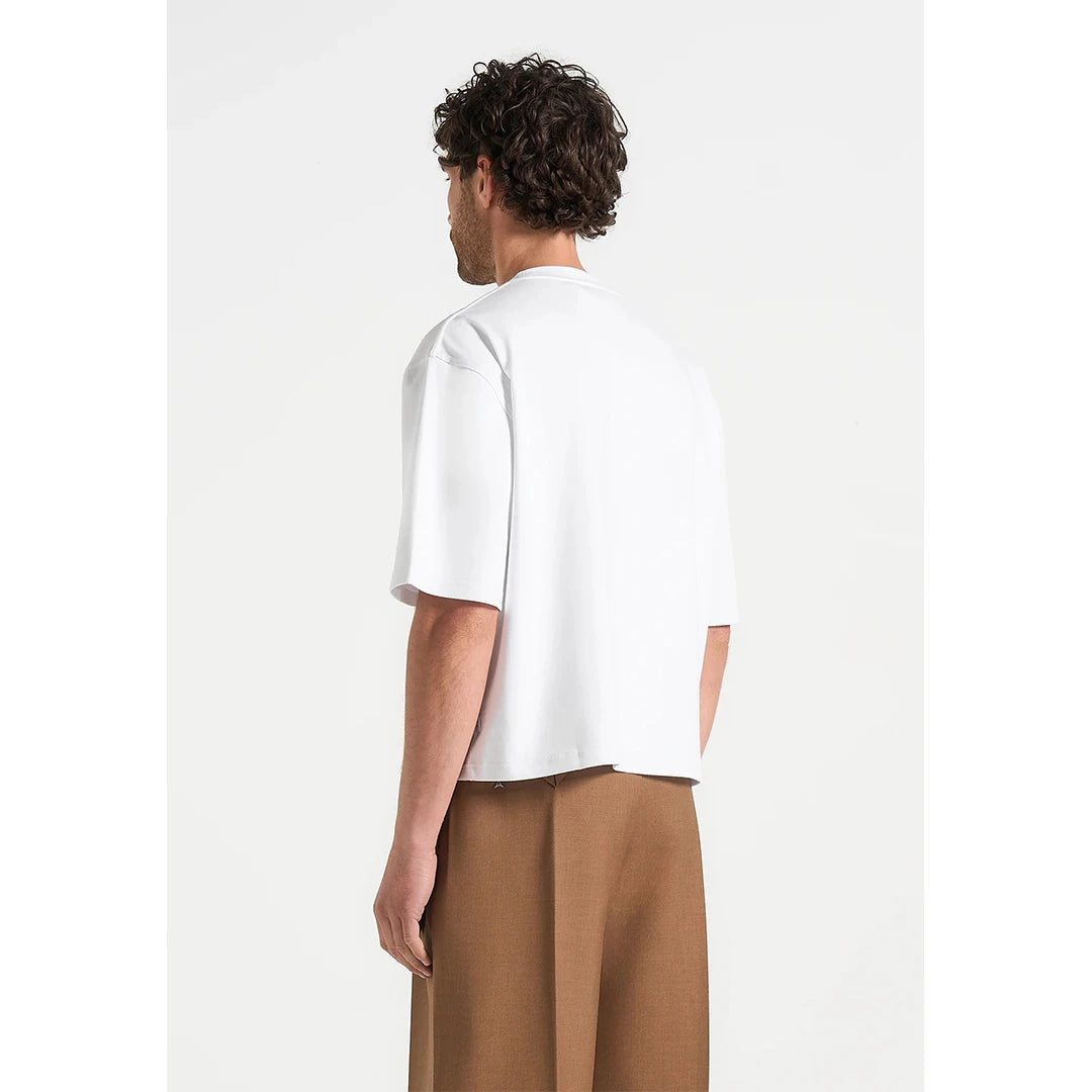 Person wearing a white t-shirt and brown pants on a white background