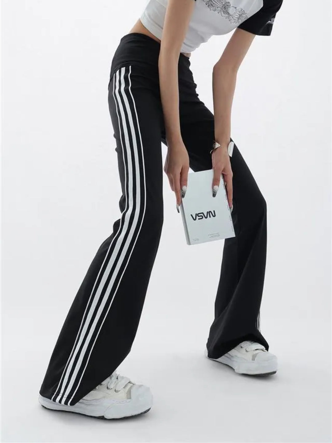 black flare leggings with white stripes on the side