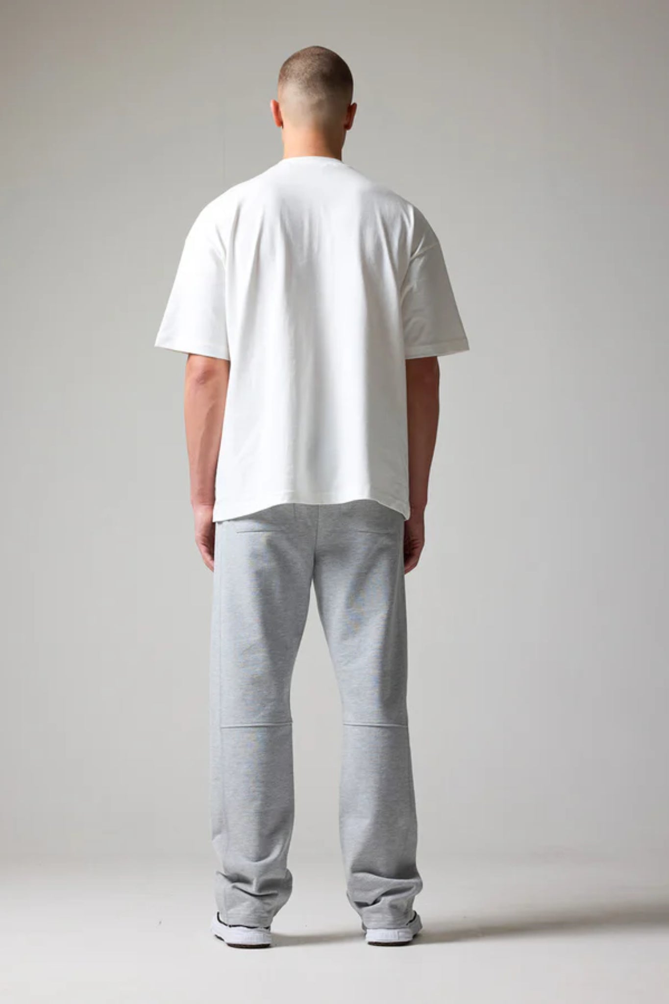 wearing grey open hem joggers with an elastic waistband and drawstring with back pockets