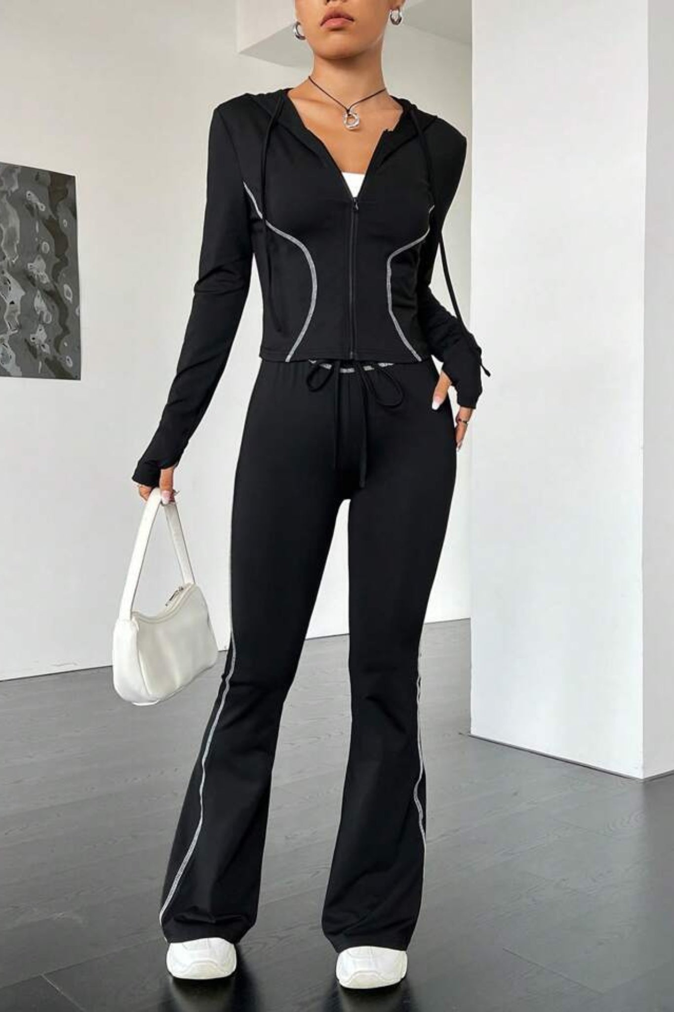black contrast stitch tracksuit with a zip-up jacket and matching leggings