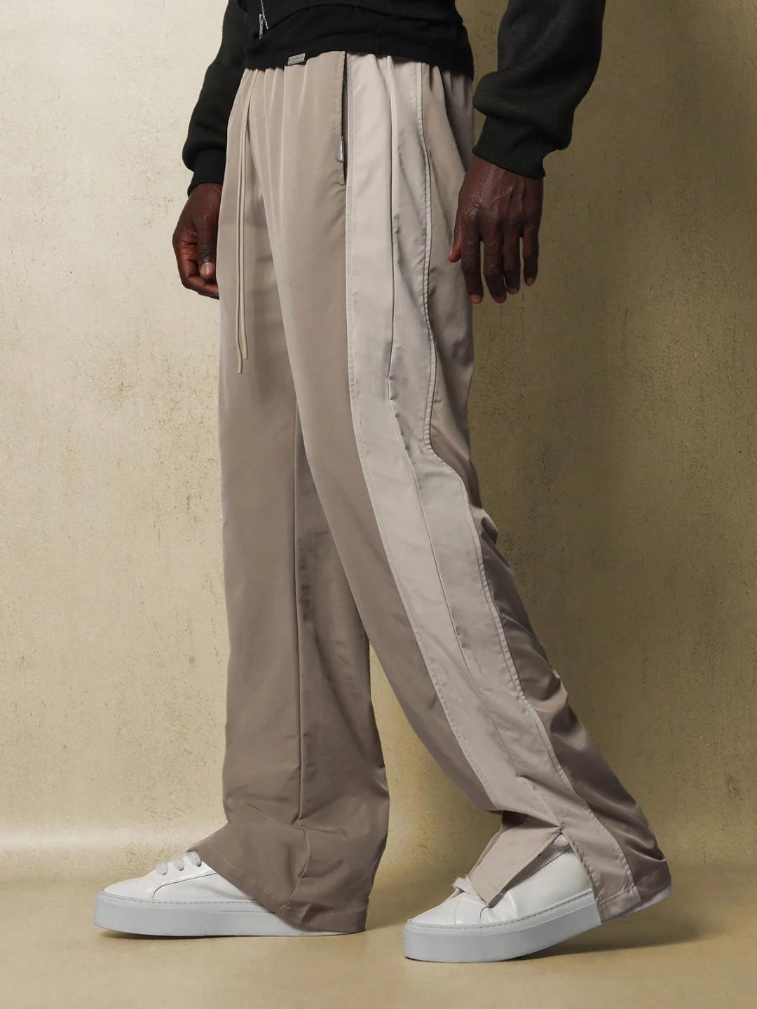 Core Pants, designed with simplicity and comfort in mind. The pants are gray, featuring a sleek and straight fit that accentuates a casual yet chic look.