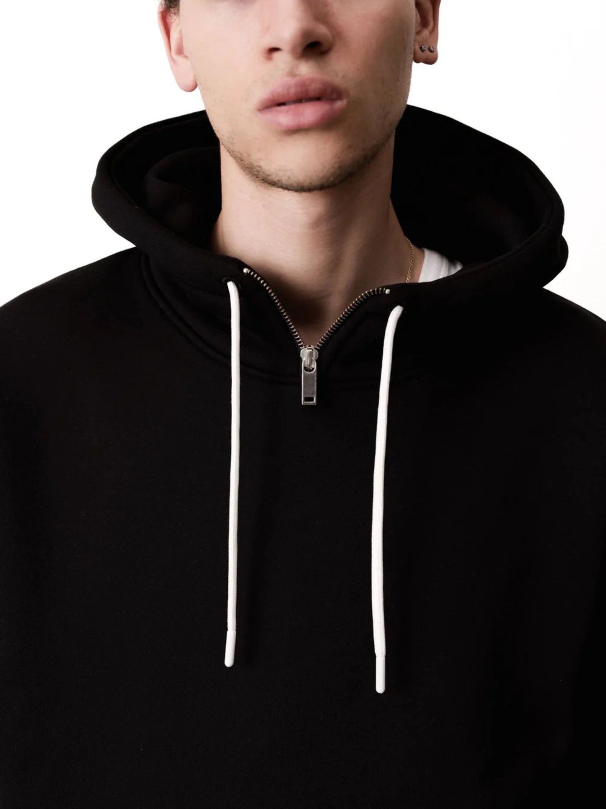Black hoodie with white drawstrings on a plain background