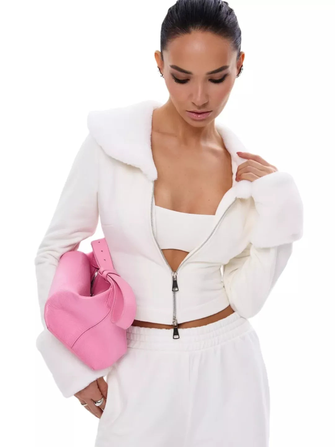 Woman holding a pink bag against a white background