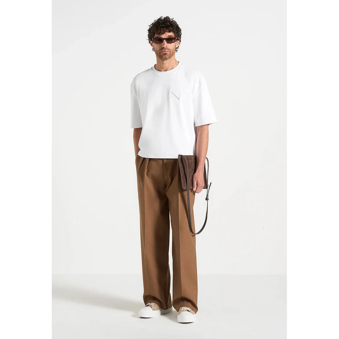 Man wearing a white t-shirt and brown pants on a white background