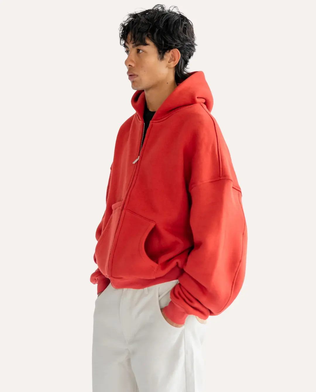 Person wearing a red hoodie on a white background