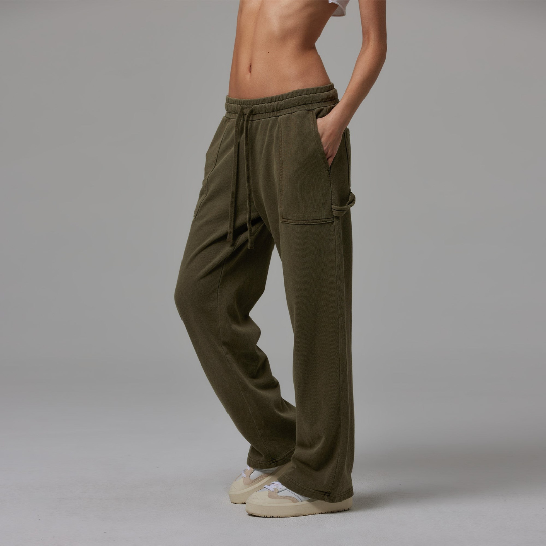 Olive jersey carpenter sweatpants with an adjustable toggle hem at the ankle, featuring multiple pockets.