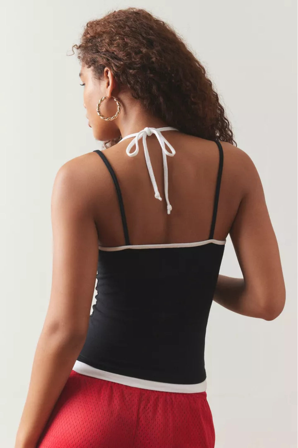 Black layered cami top with thin straps and a white waistband