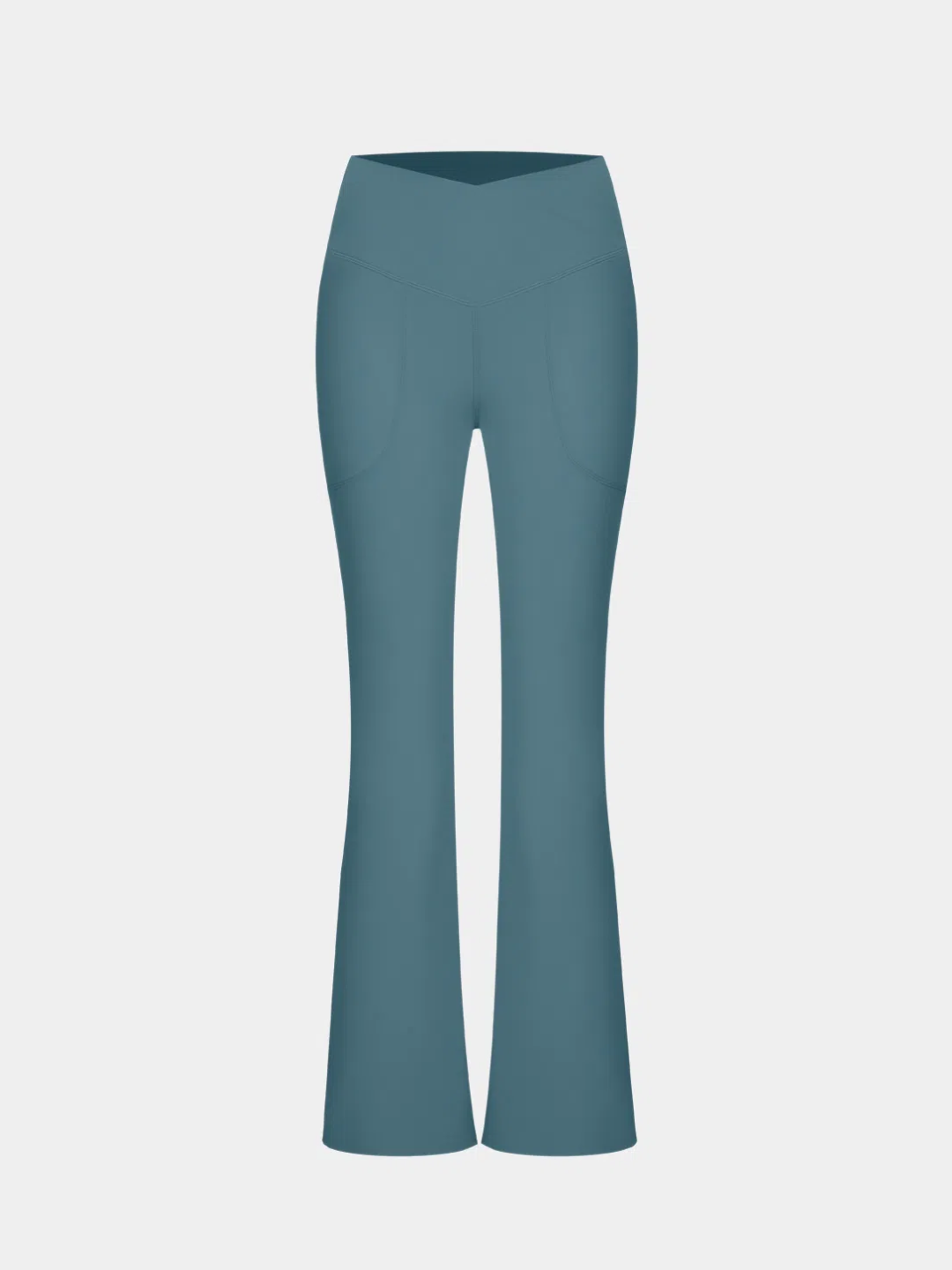A person wearing teal flare leggings with a split hem, paired with a white cropped top and white sneakers.