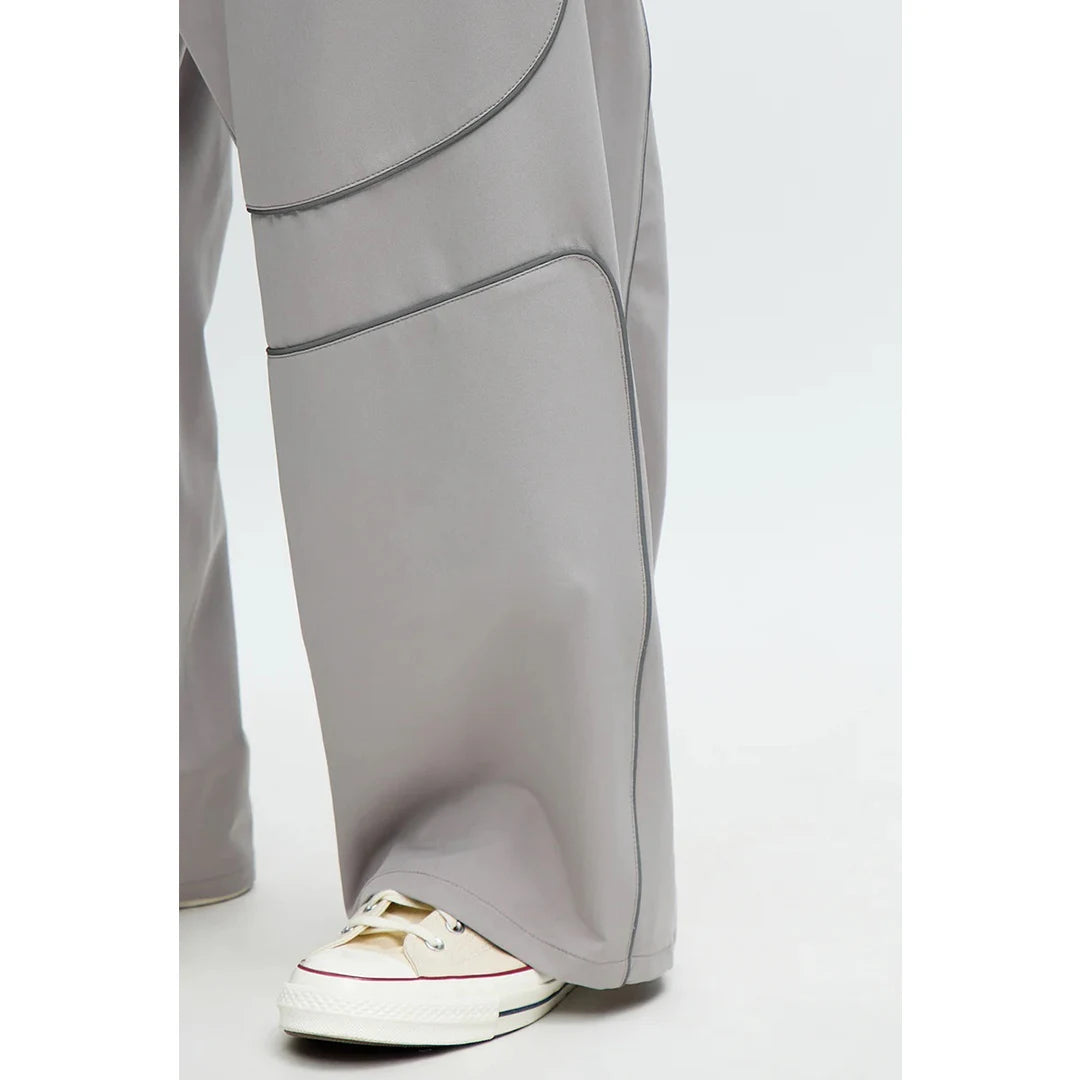 Gray wide-leg pants with a white sneaker on a white background