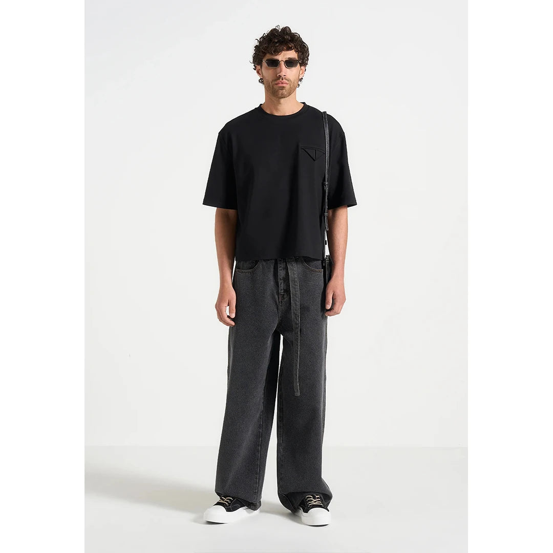 Person wearing a black t-shirt and dark pants on a white background