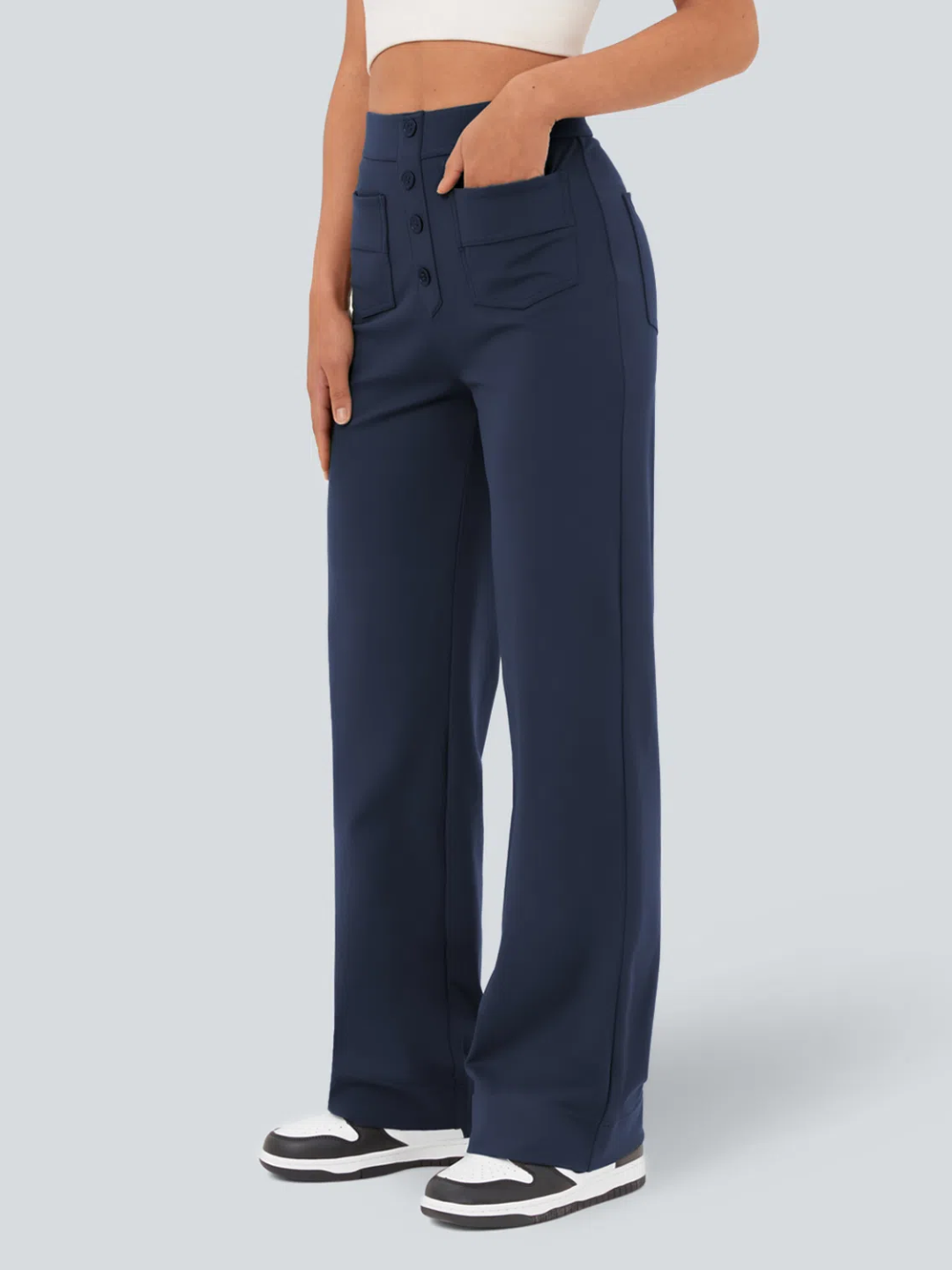 A person wearing high waisted button multiple pockets straight leg casual pants in navy color.