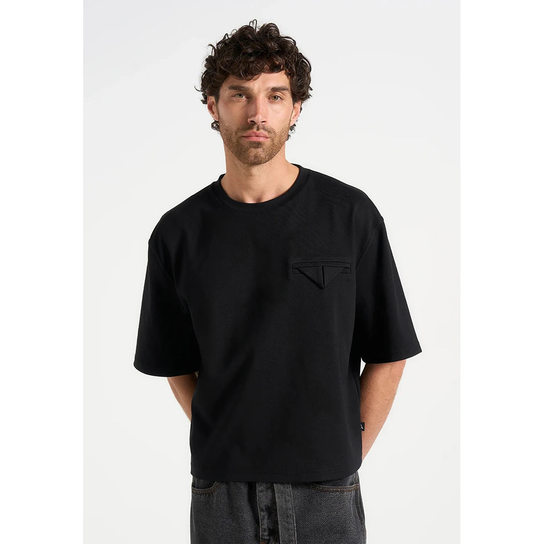 Man wearing a black t-shirt with a pocket on a white background