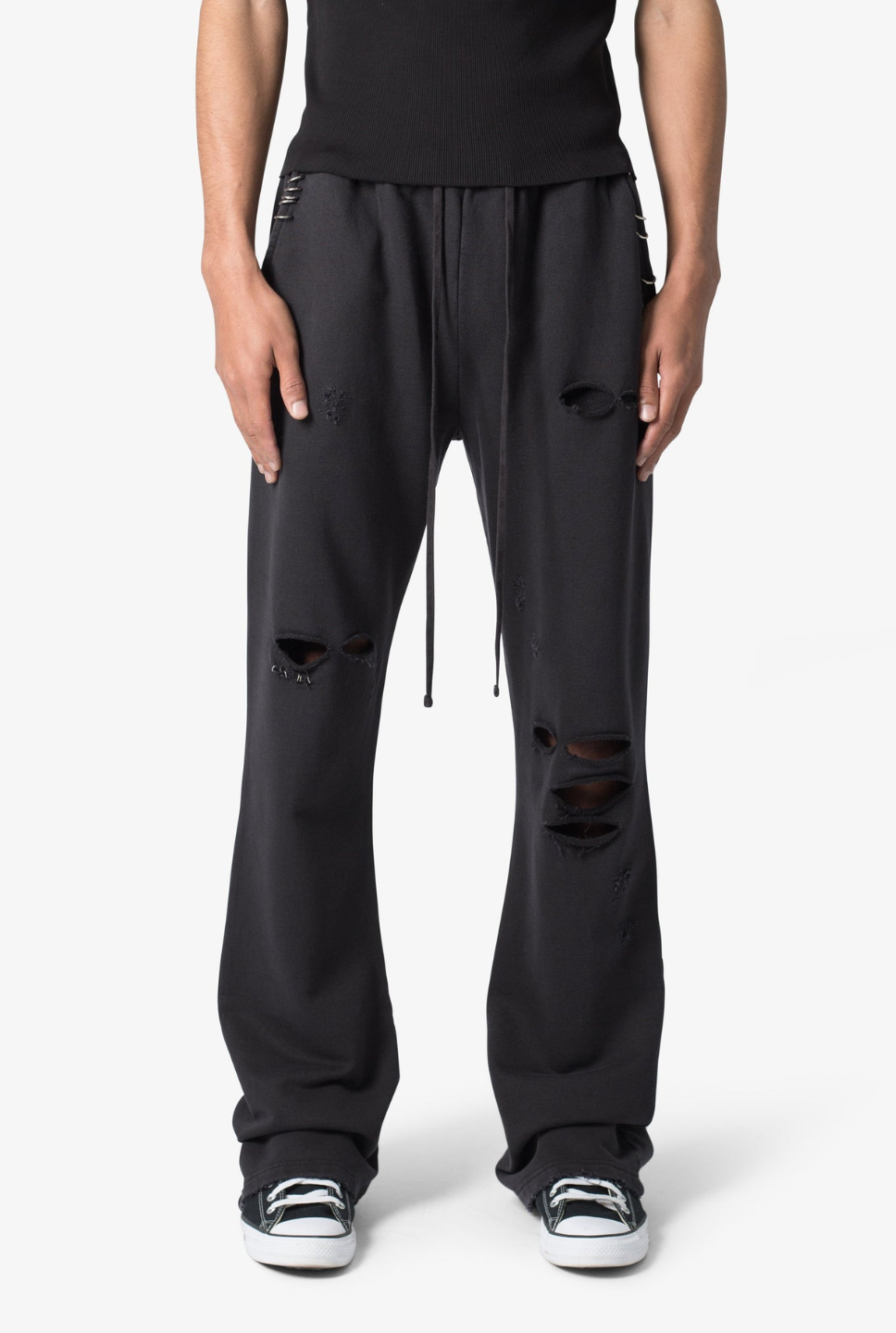 A pair of black flared sweatpants with metal ring details and a drawstring waist.