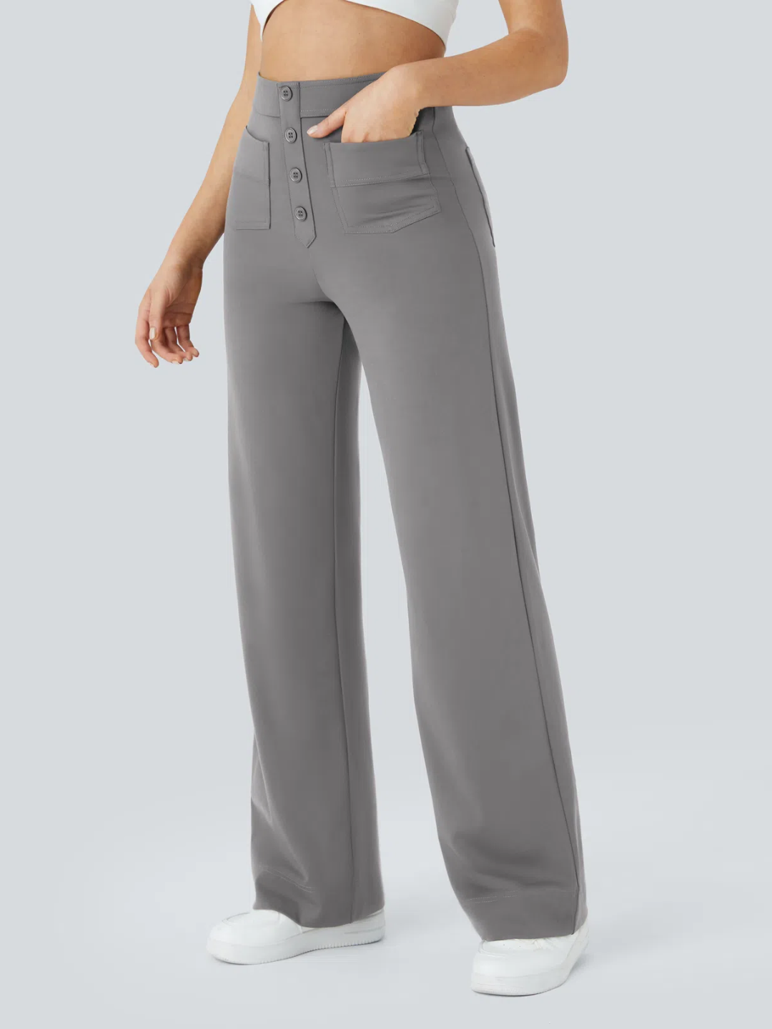 A person wearing high waisted button multiple pockets straight leg casual pants in grey color.