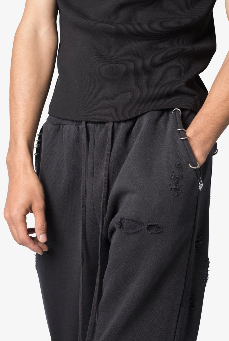 black flared sweatpants with metal ring details and a drawstring waist.