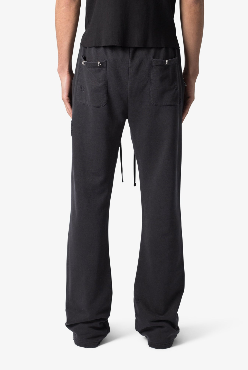 black flared sweatpants with metal ring details and a drawstring waist.