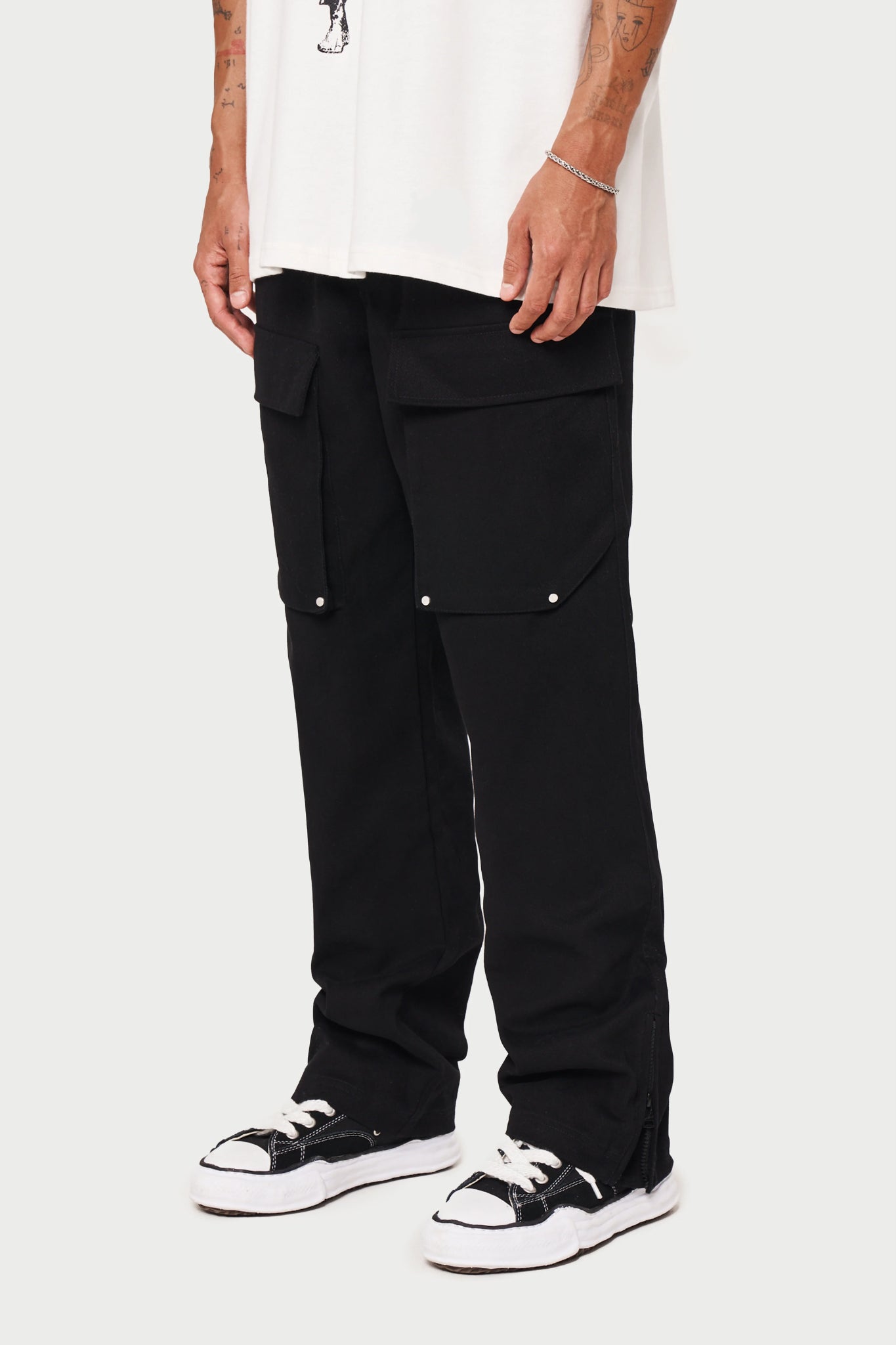 A person wearing black ripstop twill straight cargos and a white t-shirt.