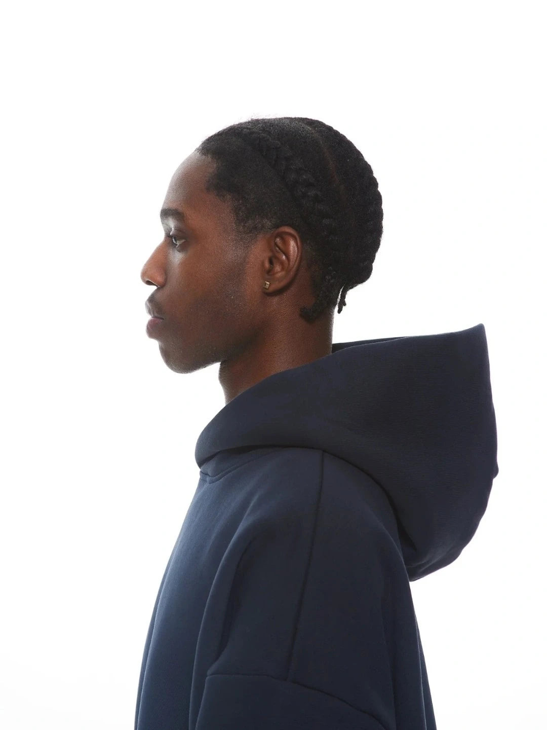 Person wearing a navy blue hoodie against a white background