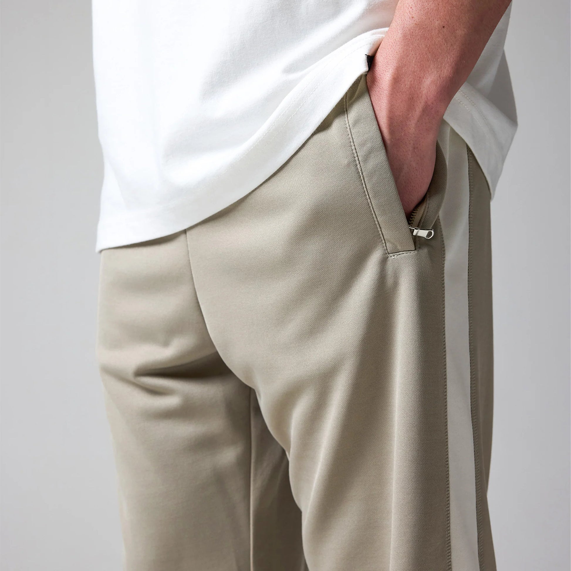 Pants worn by a person on a plain background