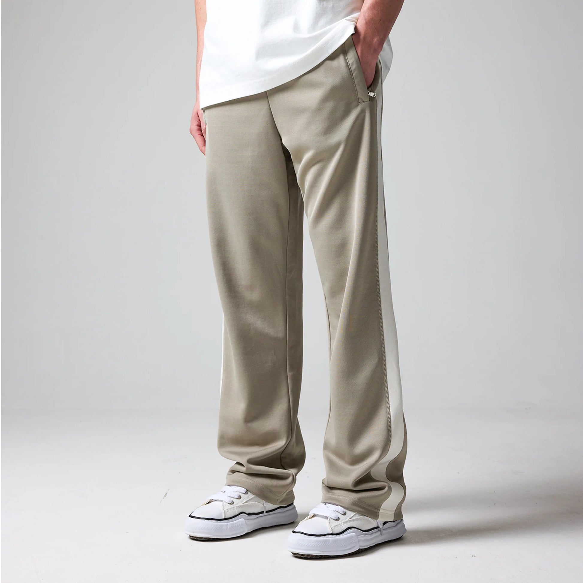 Pants worn by a person on a plain background