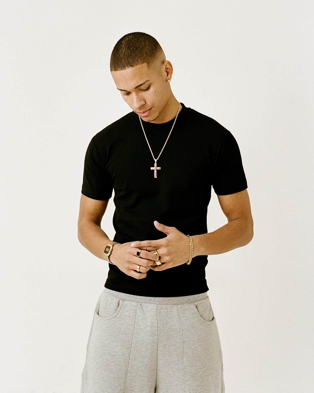 This image features a young man sporting a fitted t-shirt. The shirt is black, offering a sleek and versatile look.