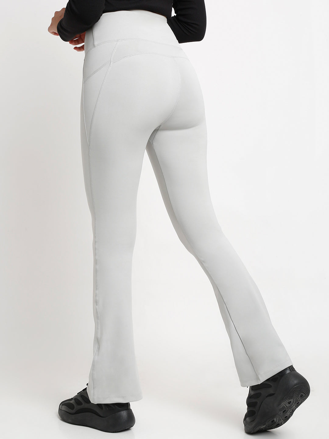 A pair of high-waisted grey flare pants with pockets, in a bootcut style.
