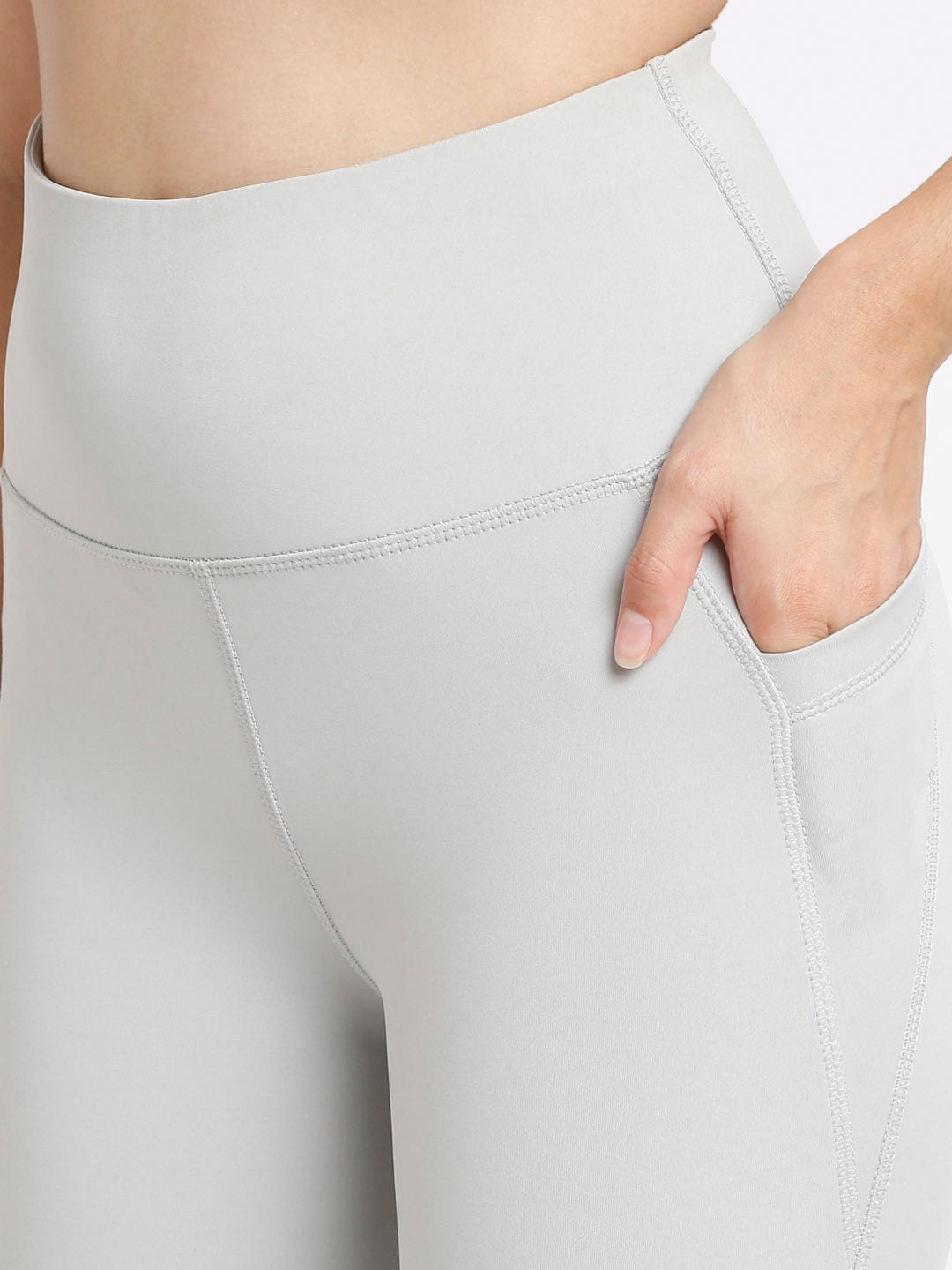 A pair of high-waisted grey flare pants with pockets, in a bootcut style.