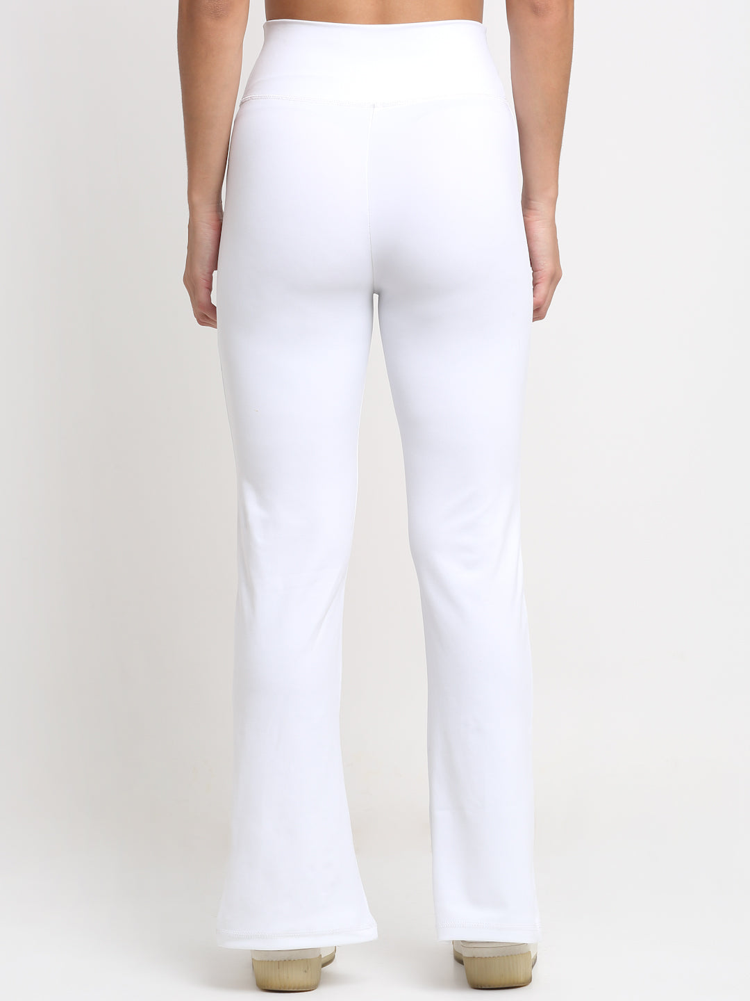 High-waisted White yoga pants with a front slit, featuring a skinny waistband and elevated front seams. The pants are designed with a flared