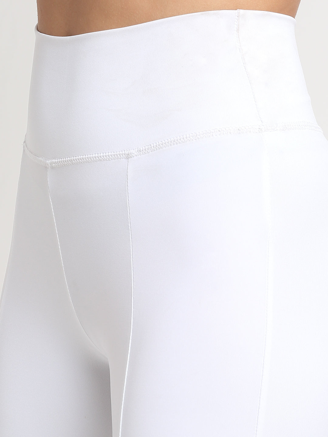 High-waisted White yoga pants with a front slit, featuring a skinny waistband and elevated front seams. The pants are designed with a flared