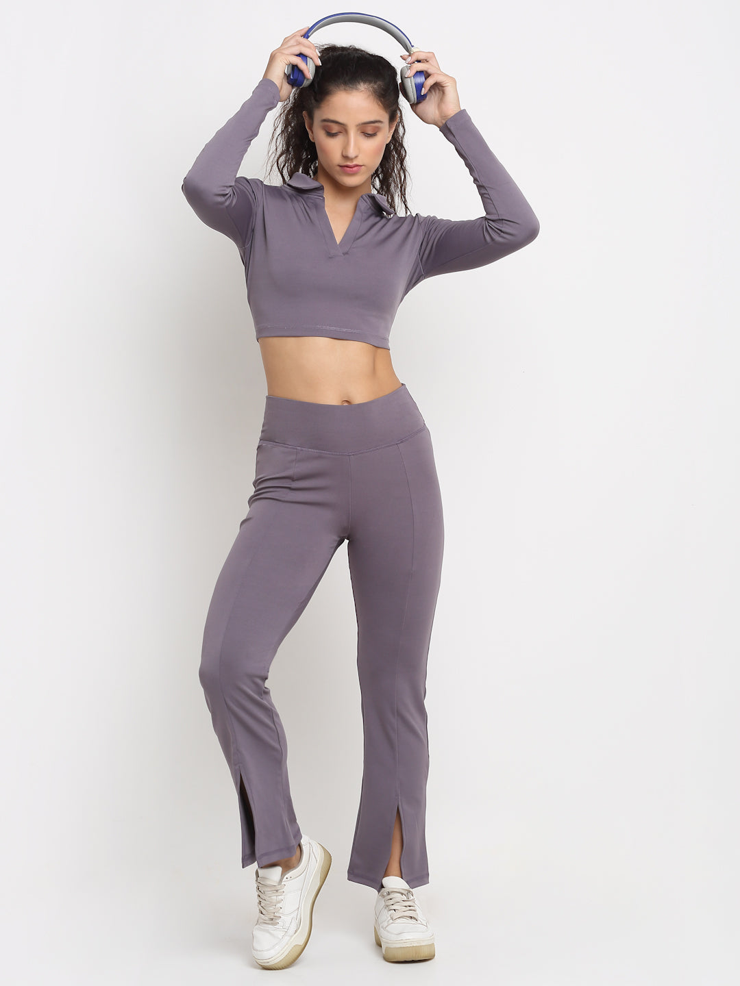 High-waisted lavender yoga pants with a front slit, featuring a skinny waistband and elevated front seams. The pants are designed with a flared