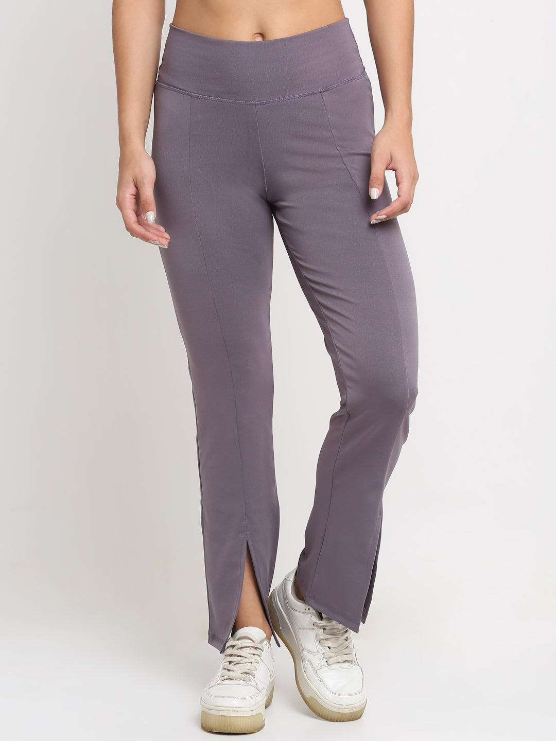A pair of leg and front split, high-waisted lavender yoga pants with a front slit, featuring a skinny waistband and elevated front seams. The pants are designed with a flared and the wearer is posing with one hand on her hip.