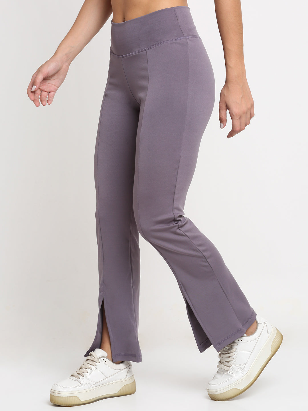 High-waisted lavender yoga pants with a front slit, featuring a skinny waistband and elevated front seams. The pants are designed with a flared