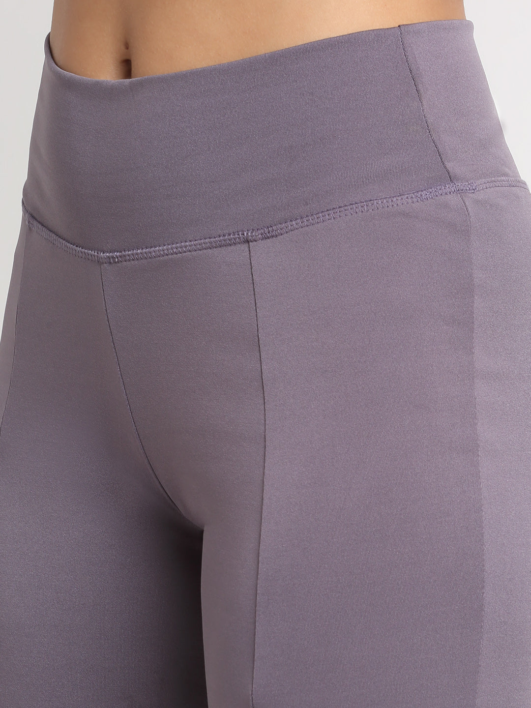 High-waisted lavender yoga pants with a front slit, featuring a skinny waistband and elevated front seams. The pants are designed with a flared