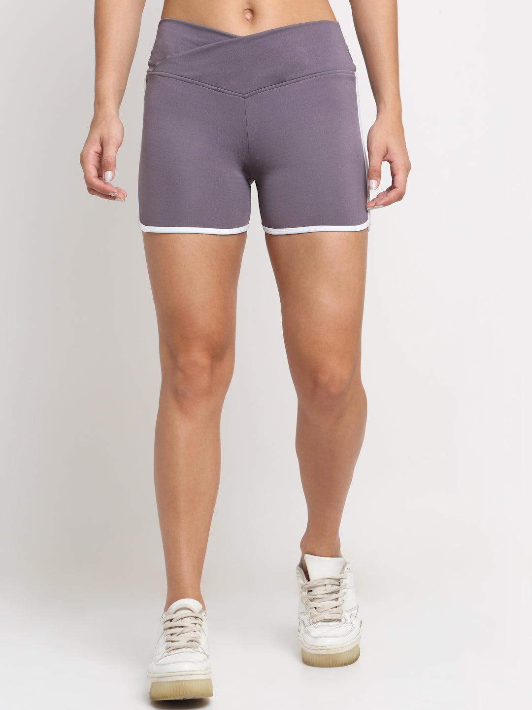 A pair of women's running shorts in lavender color with contrasting white piping, displayed on a model without showing the upper part of the body.