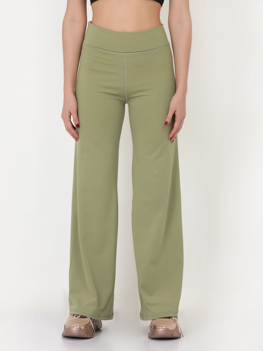 A pair of green flared high-rise full-length yoga pants on a female model.