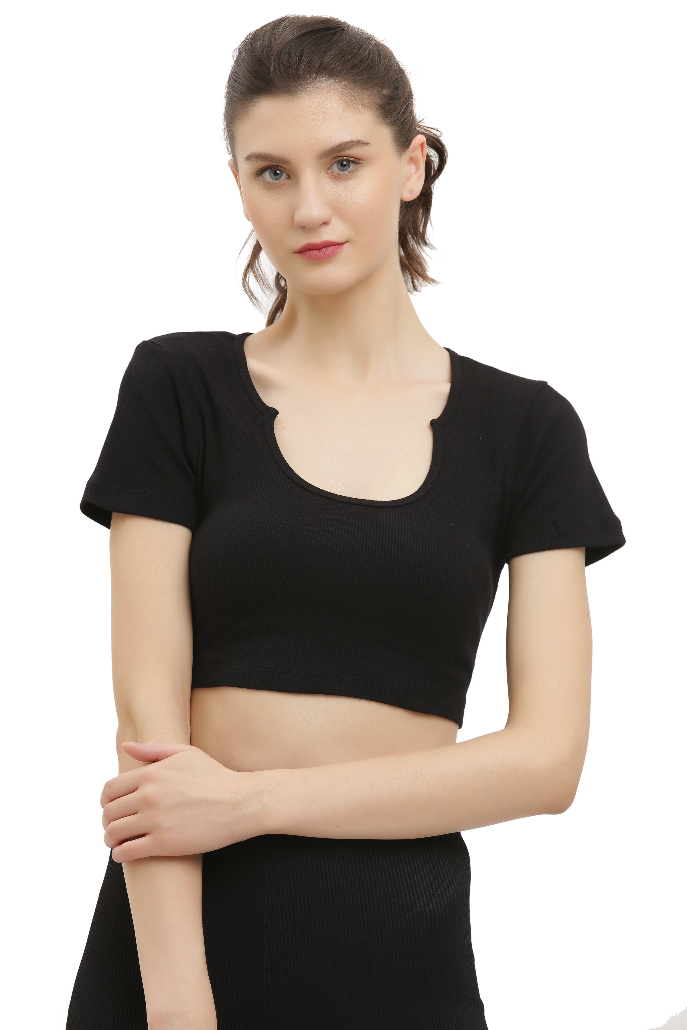 A woman wearing a black half sleeve rib crop top