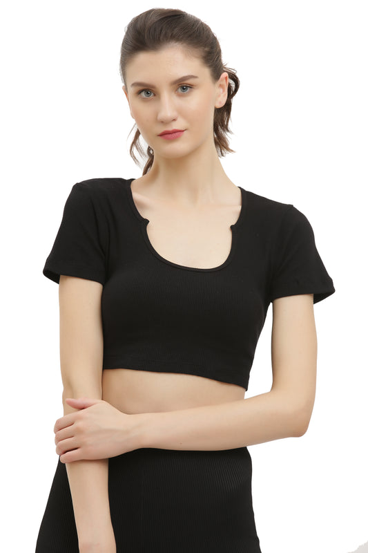 A woman wearing a black half sleeve rib crop top