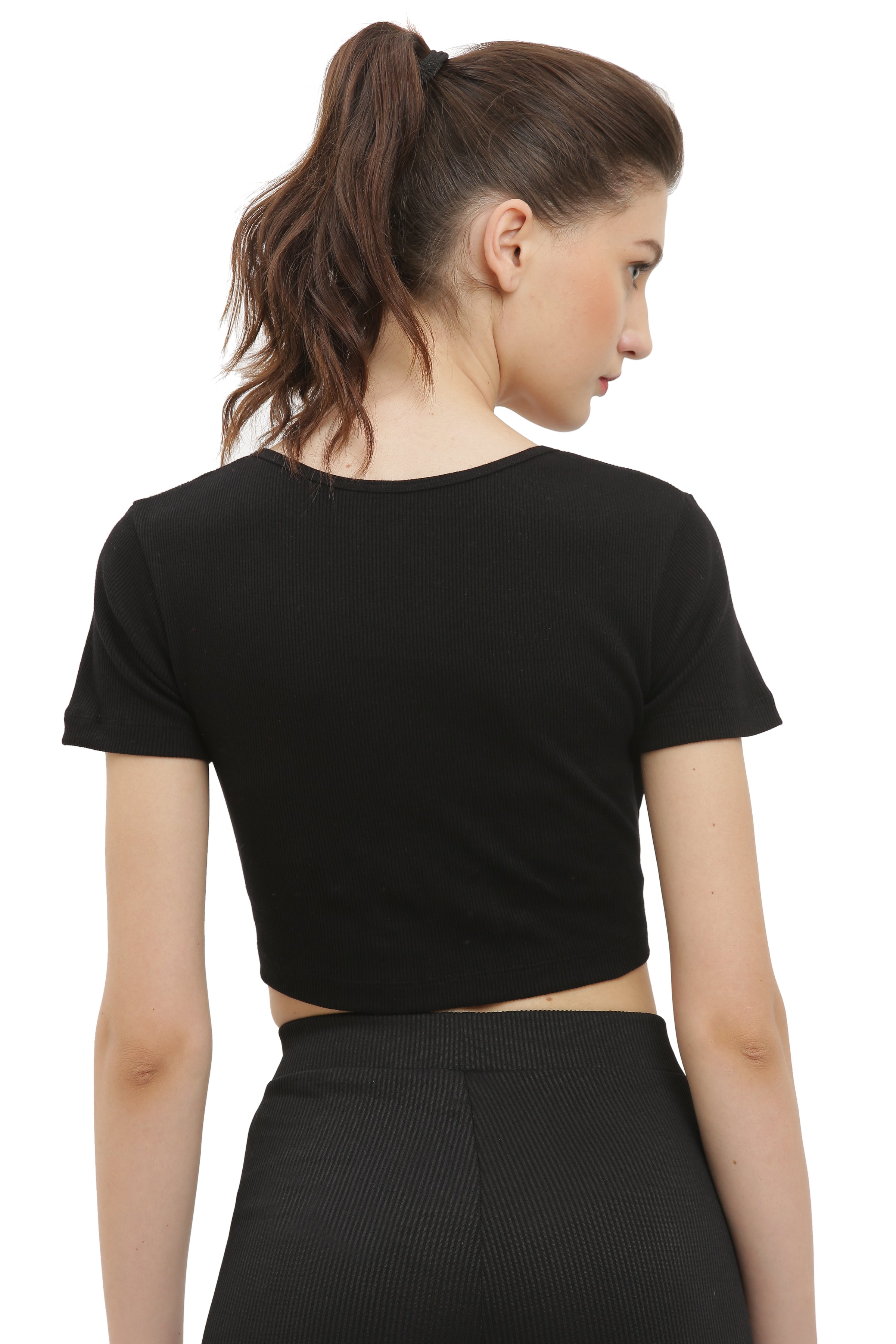 A woman wearing a black half sleeve rib crop top