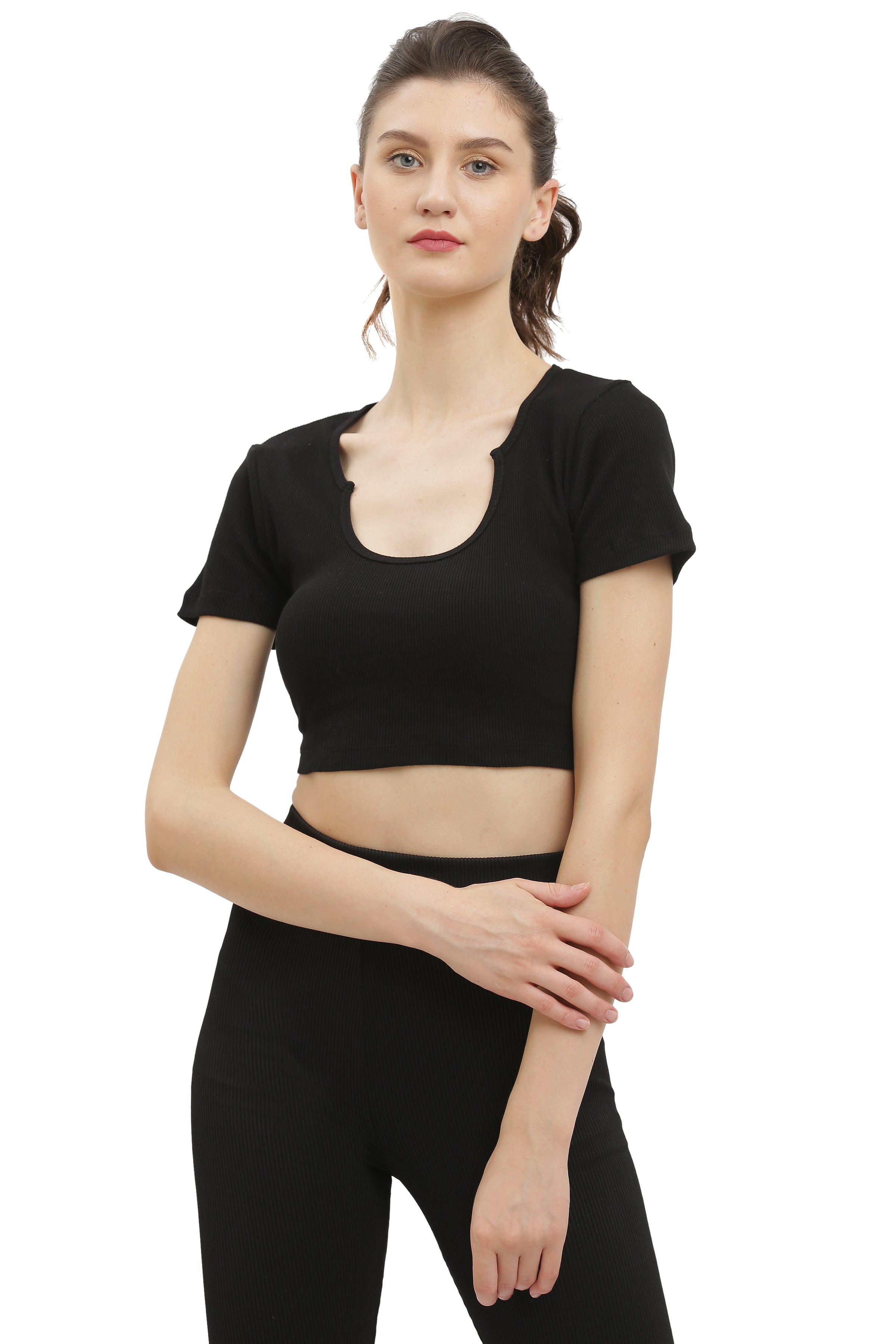 A woman wearing a black half sleeve rib crop top