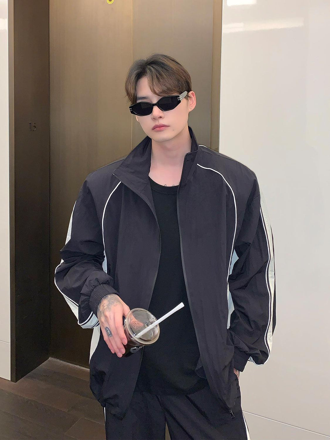 black tracksuit with white stripes