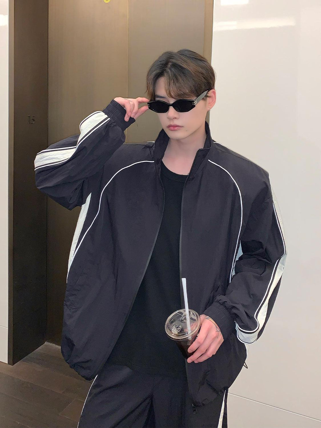 black tracksuit with white stripes