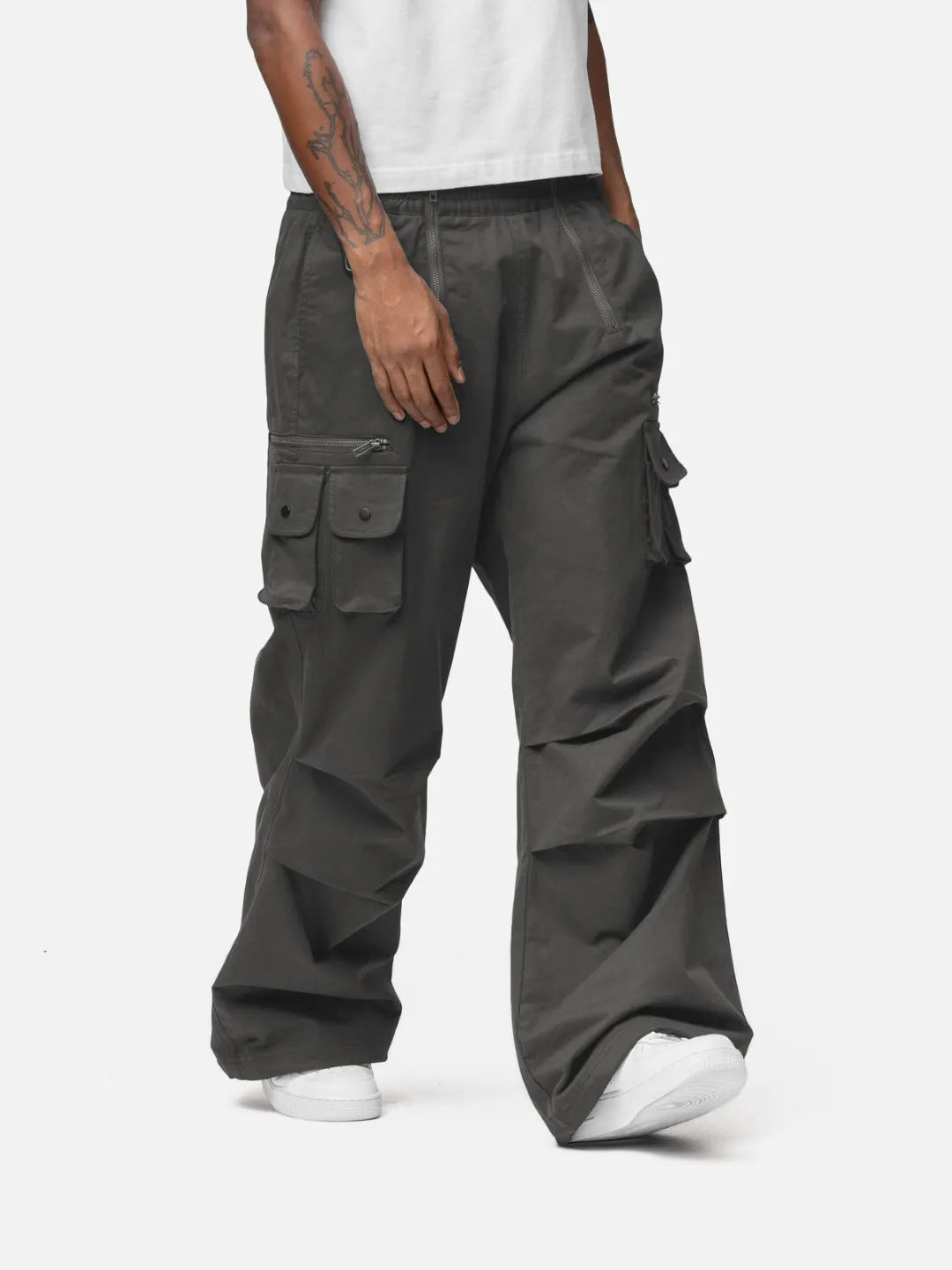 Grey cargo pants with adjustable drawstrings and pockets on a white background